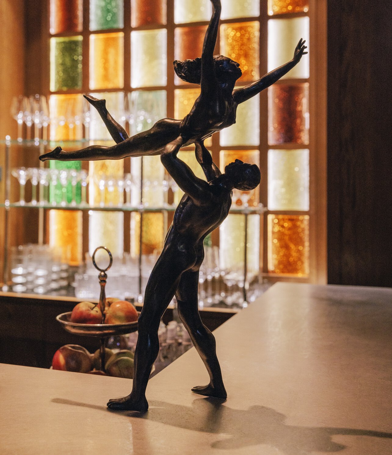 Bronze sculpture of a dancer whirling his dance partner into the air for a lifting figure, on display at the Château Royal event location in Berlin Mitte